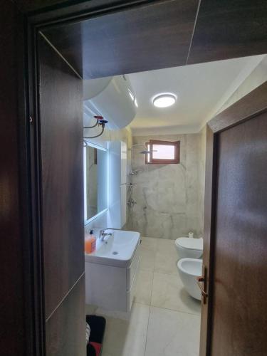 a bathroom with a sink and a toilet at Guesthouse Rama in Valbonë