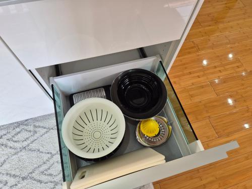an open drawer with a bowl and other dishes in it at Juliana Apartment Bohinj Lake in Bohinj