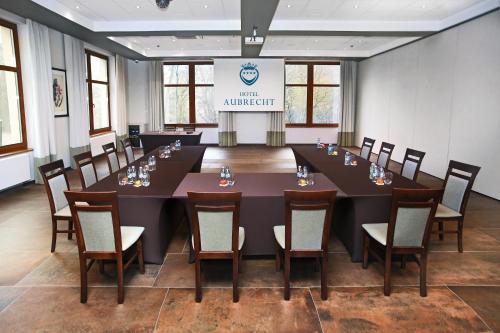 a conference room with a large table and chairs at Hotel Aubrecht Country Spa Resort in Przechlewo