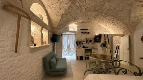a living room with a table and a dining room at La bottega di zia Tetta - Luxury Home in Ceglie Messapica