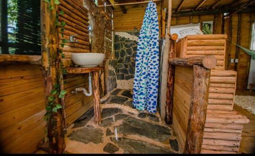 a bathroom in a log cabin with a sink at Cabarete Ecolodge Encuentro Surf Beach Kite in Perla Marina by BTCG Crypto in Bombita