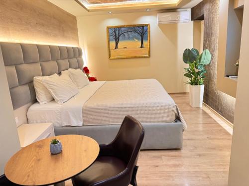a hotel room with a bed and a table and a table at 4R Colombo Hotel in Tirana