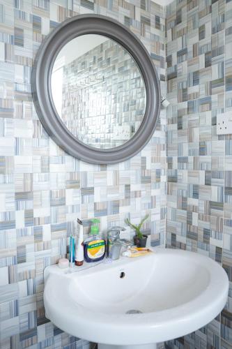 a bathroom with a white sink and a mirror at House of Sincerity in Maharagama