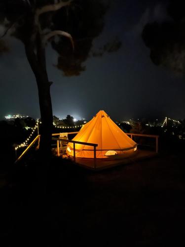 an orange tent is lit up at night at Villa Conti Residence in Lacona
