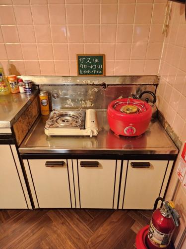 a kitchen counter with a stove and a pot on it at いすみエンガワのある古民家 in Isumi