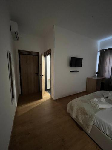 a bedroom with a bed and a television on the wall at La Terrazza in centro in Marsala