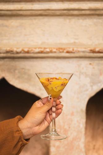 a person holding a drink in a martini glass at Casa Hoyos - Hotel Boutique in San Miguel de Allende