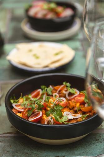a pan of food sitting on top of a table at Casa Hoyos - Hotel Boutique in San Miguel de Allende