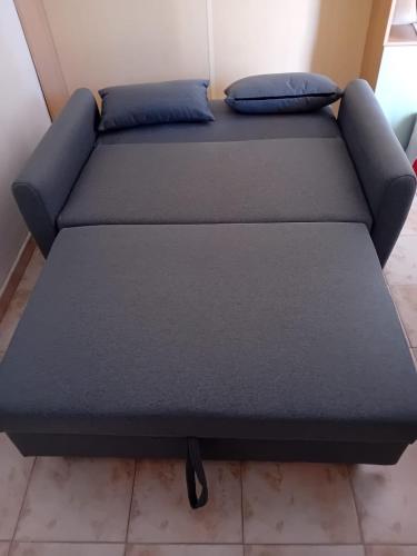 a bed in a room with two pillows on it at The Lion's Head in Olbia