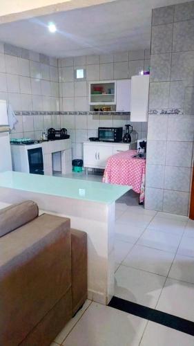 a kitchen with a table in the middle of a room at Casa em lumiar in Nova Friburgo