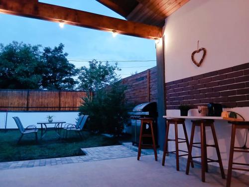 a patio with a grill and a table and chairs at Popa Cabana in Sibiu