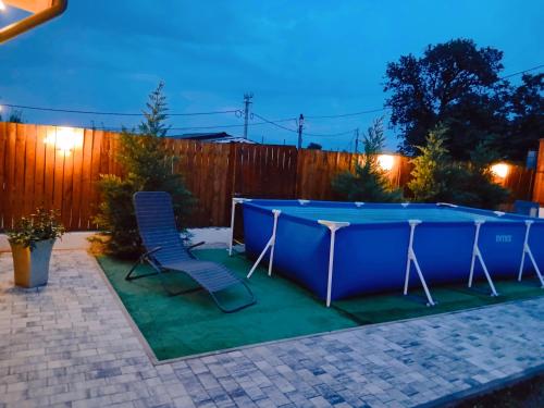 a pool table and chairs in a backyard at night at Popa Cabana in Sibiu
