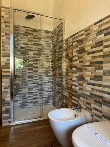 a bathroom with a tub and a sink and a shower at Belvedere MareMonti in Belvedere Ostrense