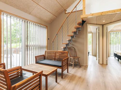 a living room with two benches and a staircase at 5 star holiday home in Hadsund in Hadsund