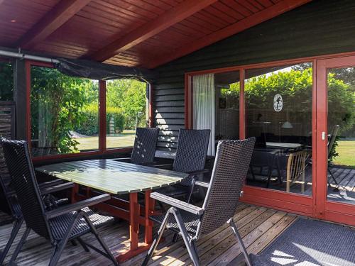 a patio with a table and chairs on a deck at 6 person holiday home in Dannemare-By Traum in Dannemare