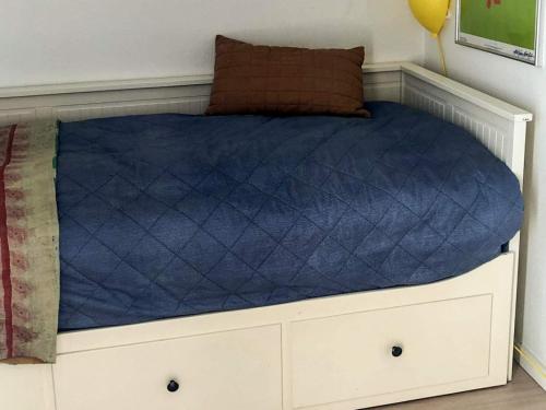a bed in a room with a blue mattress at 6 person holiday home in Skibby-By Traum in Skibby
