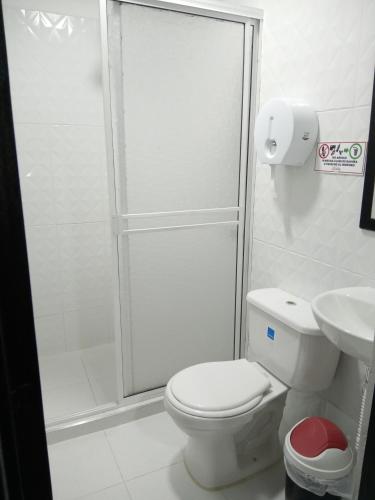 a bathroom with a shower and a toilet and a sink at Hostal las vegas Malaga in Estación El Salto
