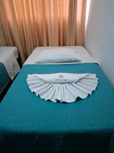 a white shirt on a bed in a room at Hostal las vegas Malaga in Estación El Salto