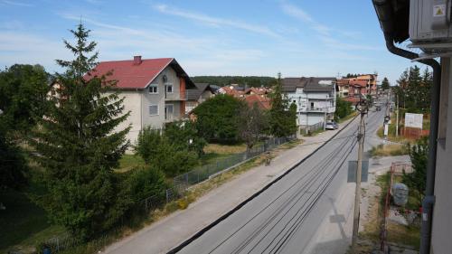 a city street with houses and a train tracks at Apartments Kayaville in Sjenica