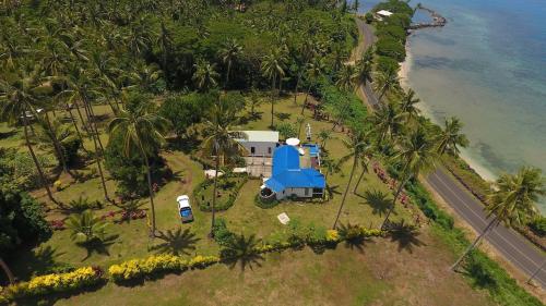 an aerial view of a house next to the ocean at Lomani in Matei