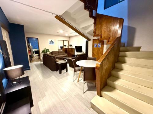a room with a staircase and a living room at RMS Hostal - Condesa in Mexico City