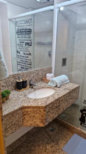 a bathroom counter with a sink and a mirror at Studio Orion in Rio de Janeiro