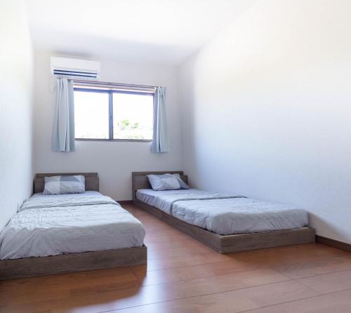 Postel nebo postele na pokoji v ubytování Links seaside resort -ビーチまで徒歩1分&サウナ完備-
