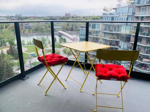 a table and two chairs on a balcony at Scenic 2BR RiverView Suite in Downtown in Calgary