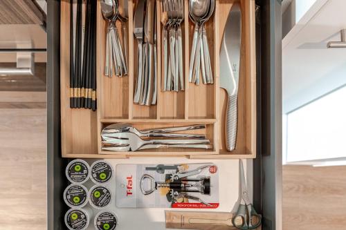 a drawer filled with utensils in a kitchen at Scenic 2BR RiverView Suite in Downtown in Calgary