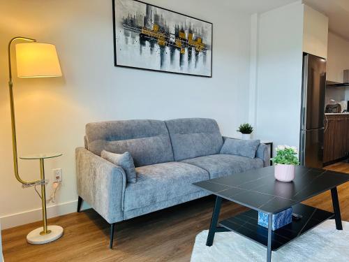 a living room with a couch and a table at Scenic 2BR RiverView Suite in Downtown in Calgary