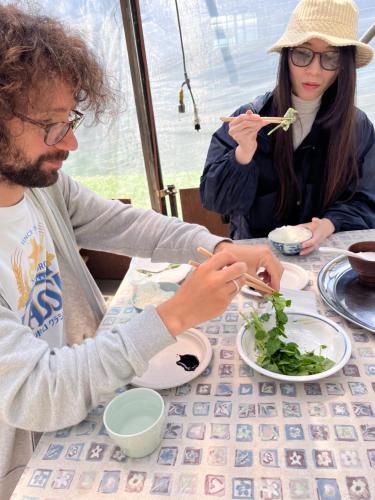 a man and woman sitting at a table eating food at Boken Kazoku in Kutchan