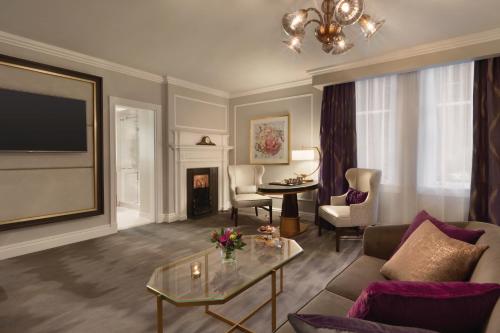 a living room with a couch and a table at Fairmont Empress Hotel in Victoria