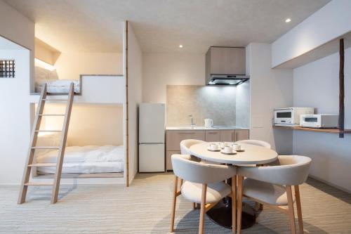 a small apartment with a table and chairs and a kitchen at ENT TERRACE Asakusabashi in Tokyo