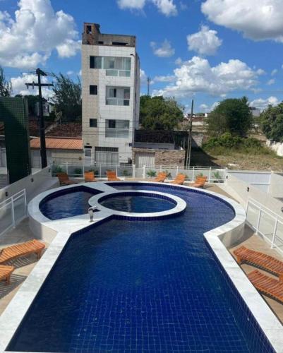 a swimming pool on the roof of a building at Catolé Comfort Flat in Campina Grande