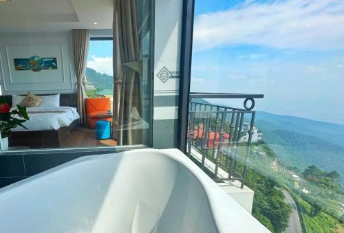 a bath tub in a bathroom with a view of a bedroom at Time Villa in Tam Ðảo
