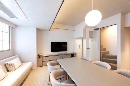 a living room with a table and a couch at ENT TERRACE Asakusabashi in Tokyo