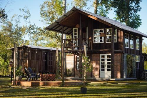 una pequeña casa con techo en Chalé Celeiro em frente ao lago, en Rolante
