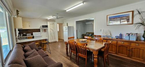 a kitchen and dining room with a table and chairs at Patrick Crescent 18 - Kalbarri, WA in Kalbarri