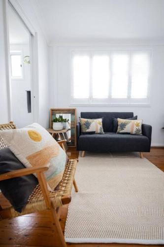 a living room with a couch and a rug at Sea Cliff Sands Gerroa in Gerroa