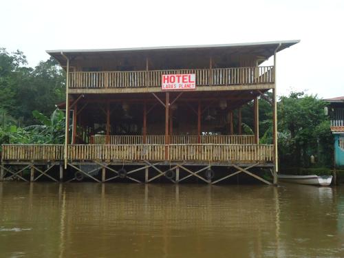 a restaurant on a dock on a river at Hotel Lara's Planet in El Castillo de La Concepción