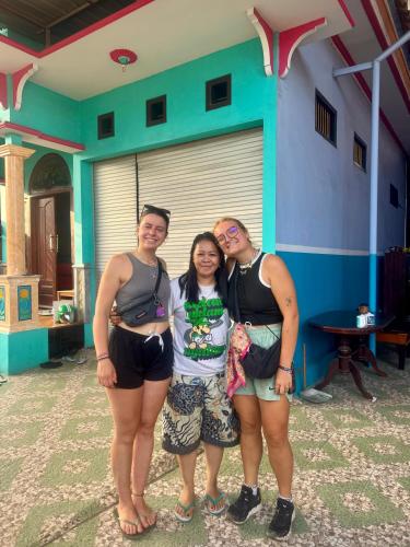 a group of three women standing in front of a building at Homestay Lidiya in Banyuwangi