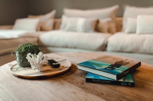 a table with two books and a plate with a plant at Excelsa- sweeping valley in Rose Valley