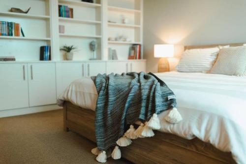 a bedroom with a white bed with a wooden drawer at Excelsa- sweeping valley in Rose Valley