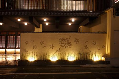 a wall with lights on the side of a building at Matsui-Bekkan Hanakanzashi in Kyoto
