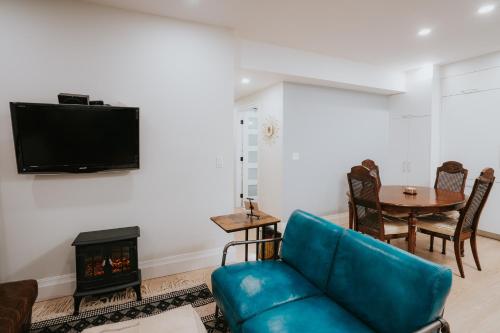a living room with a blue couch and a fireplace at A Gentle Hideaway in the Urban Forest WEST END downtown Vancouver in Vancouver