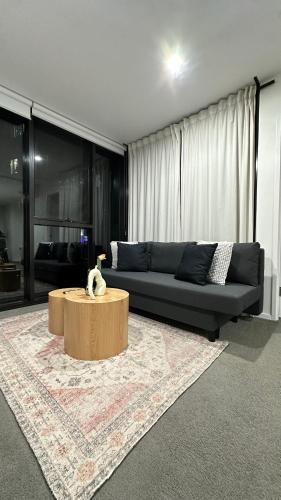 a living room with a couch and a coffee table at New & Rated Free Spa, Gym, Parking & More in Belconnen