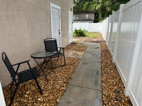 two chairs and a table next to a building at Deland Serenity Place #2 in DeLand