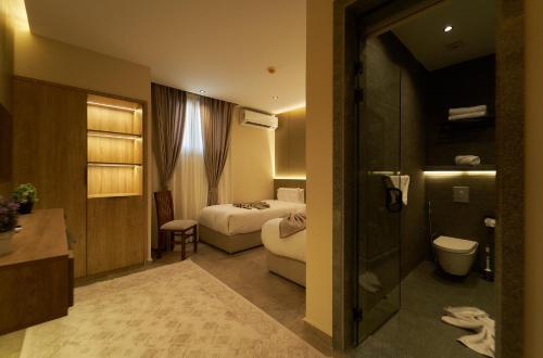 a hotel room with a bed and a bathroom at Pyramids Secret Hotel in Cairo
