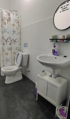 a bathroom with a toilet and a sink at Tuaran 88 Homestay in Tuaran