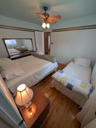 a bedroom with two beds and a ceiling fan at 2 beds in a private room B with a free parking -15 min from downtown in Longueuil
